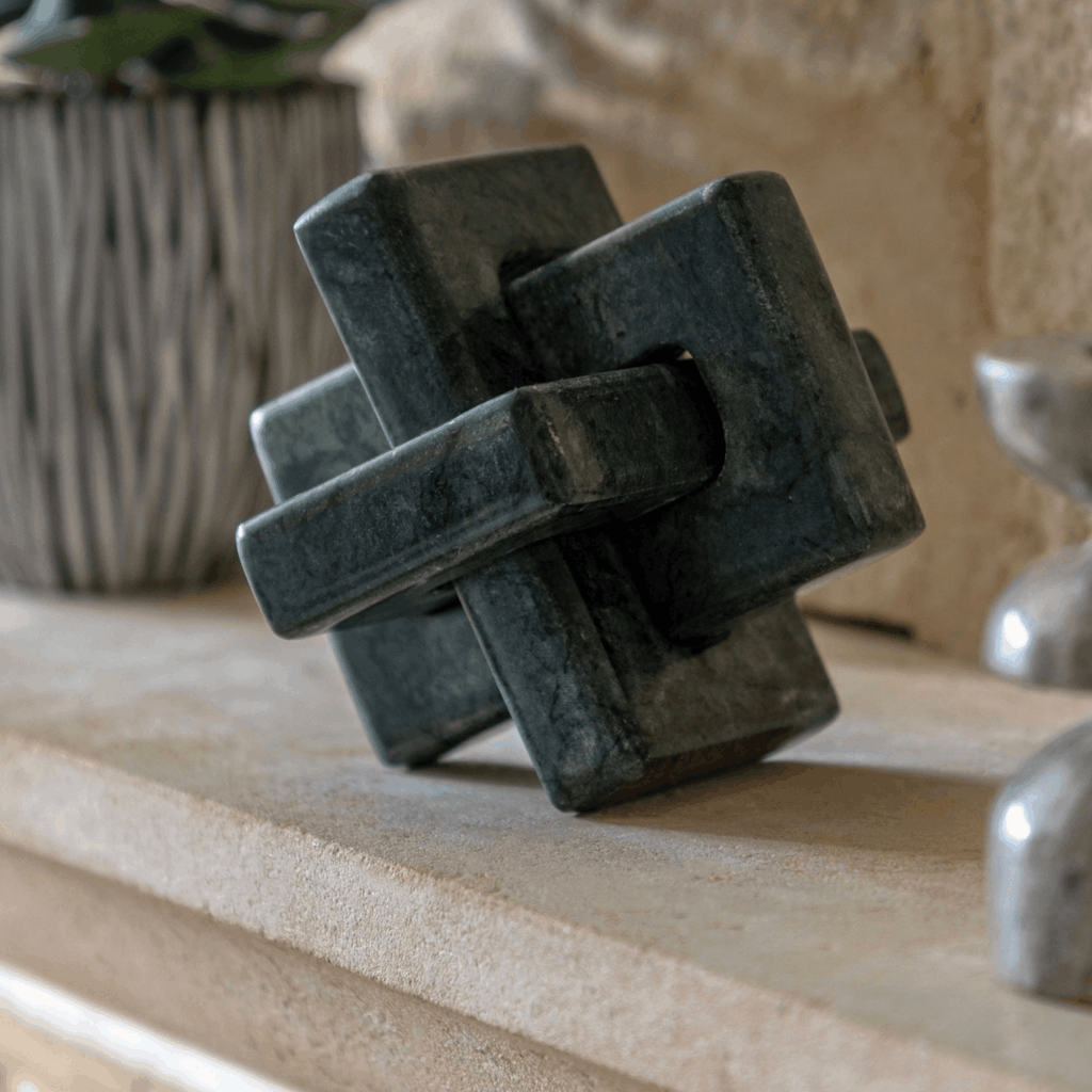 Luxury green marble sculpture with an interlocking square design, hand carved to bring texture and elegance to modern interiors.