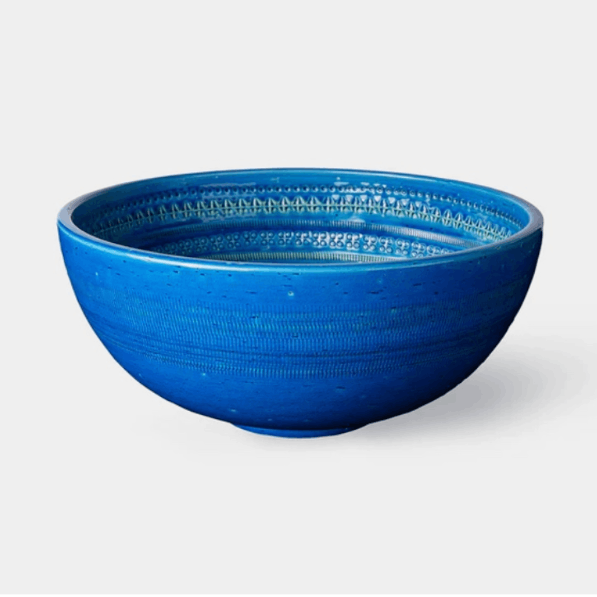 The Bitossi Bolo is a handcrafted Italian ceramic decorative bowl designed by Aldo Londi. Finished in the signature Rimini Blu turquoise glaze with intricate engraved detailing, this sculptural bowl showcases exceptional craftsmanship and the enduring design heritage of the renowned Bitossi archive.