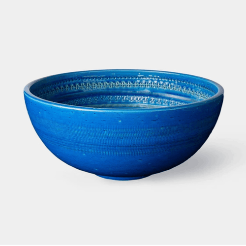 The Bitossi Bolo is a handcrafted Italian ceramic decorative bowl designed by Aldo Londi. Finished in the signature Rimini Blu turquoise glaze with intricate engraved detailing, this sculptural bowl showcases exceptional craftsmanship and the enduring design heritage of the renowned Bitossi archive.