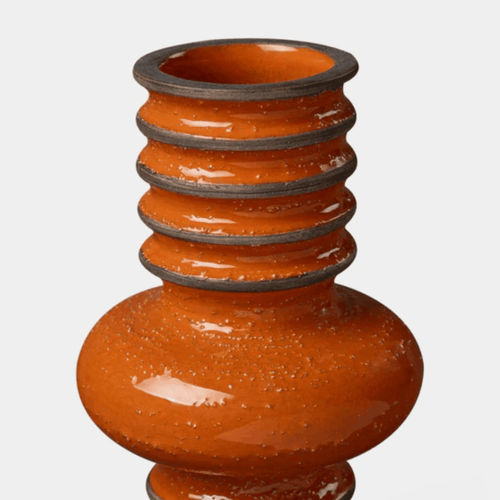 An orange ceramic vase with a textured, speckled finish and a flared, ribbed neck accented with dark gray rings, shown against a plain light gray background.
