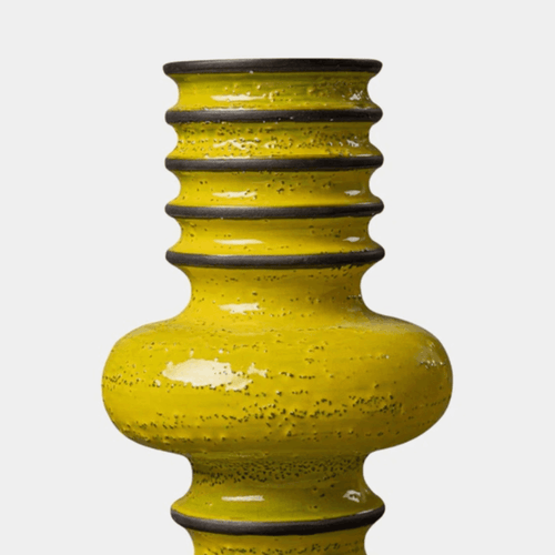A yellow textured ceramic vase with a ribbed neck and glossy finish, shown against a light gray background.