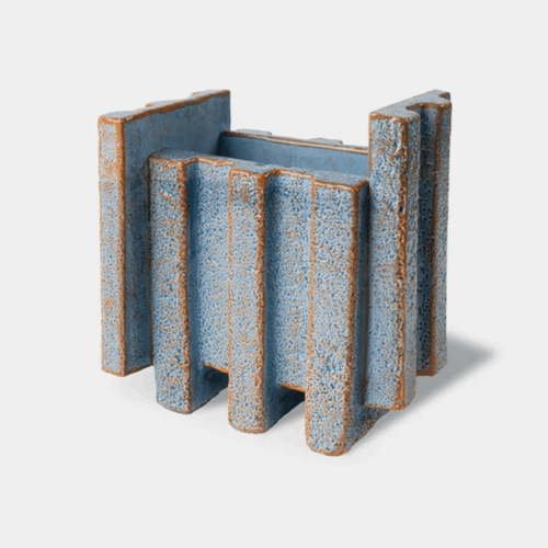 The Bitossi Patricia Urquiola Merlate Medium Blue Vase is a sculptural ceramic vase crafted from white clay and finished in a rich blue glaze. Featuring an architectural textured surface and asymmetric silhouette, it creates a striking decorative centrepiece for shelves, consoles, dining tables and contemporary interiors.