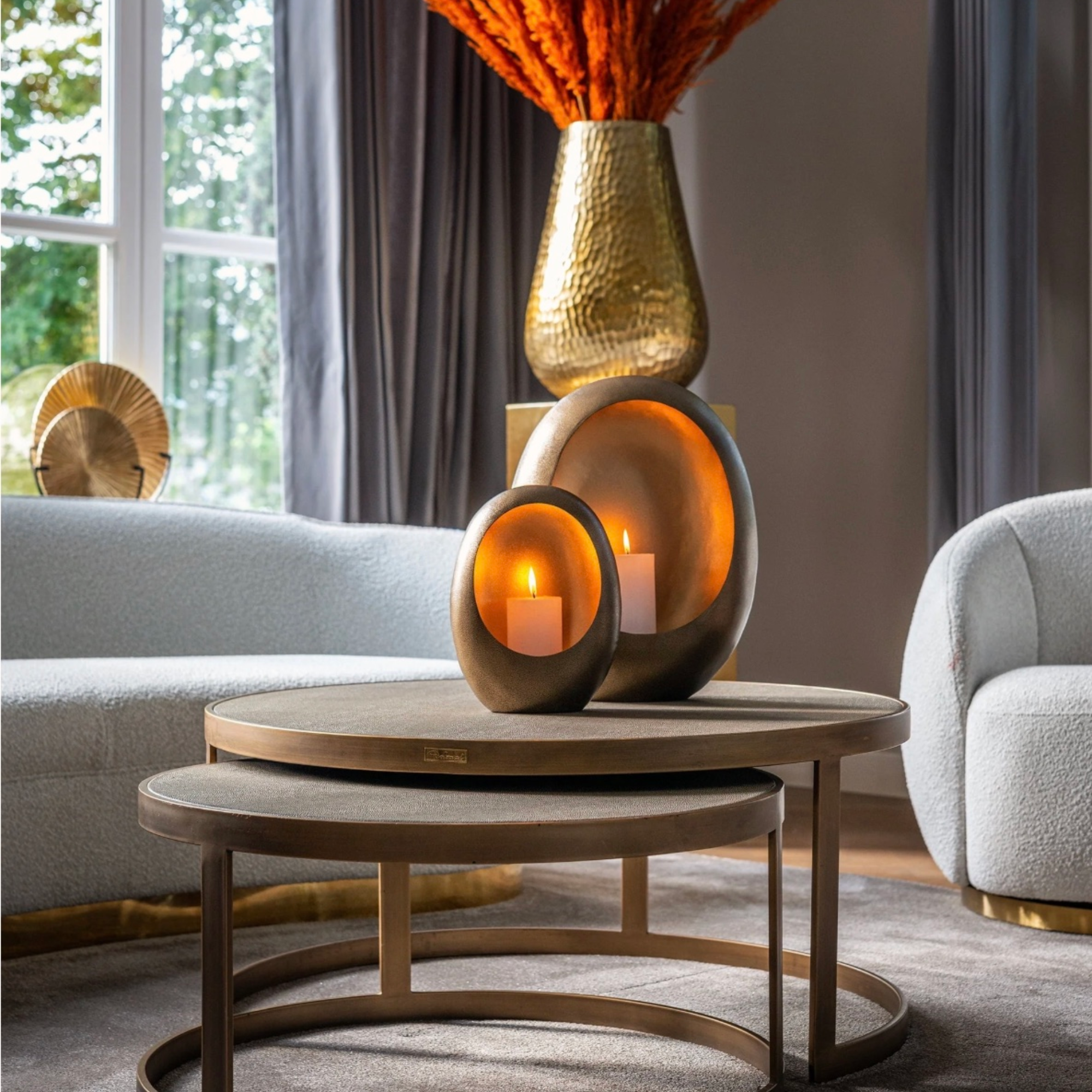 Close up of a set of 2 round coffee tables with faux segrine leather, black oak and gold metal frame – elegant Art Deco inspired design.
