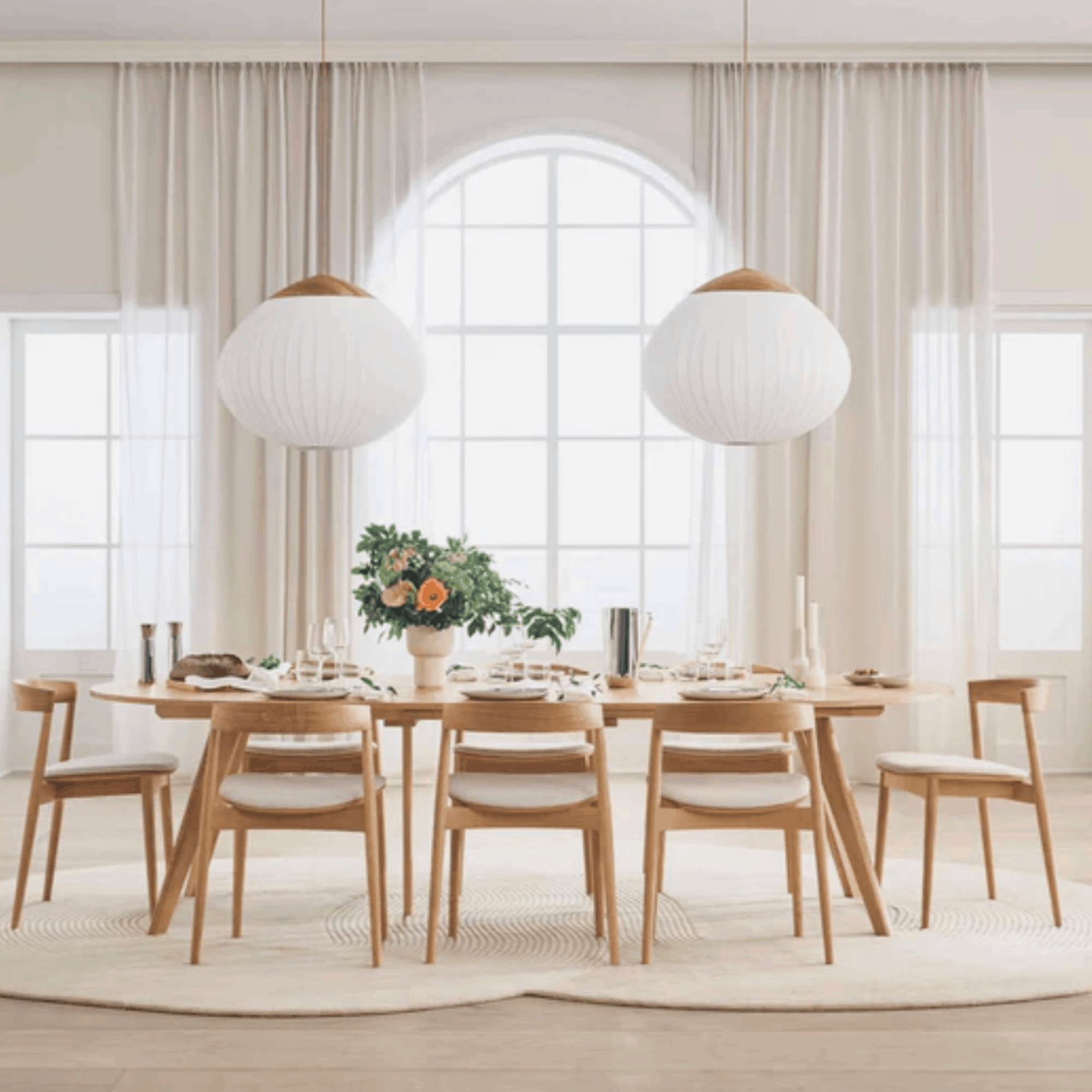 Dining room with wooden table and chairs, large windows, and pendant lights on a Bolia Zen rug.