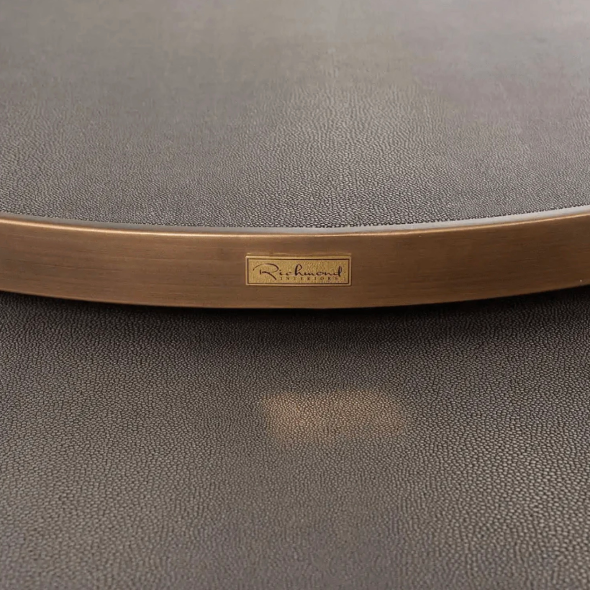 Close up of the Bloomingville coffee table top. Brass frame with faux segrine leather top