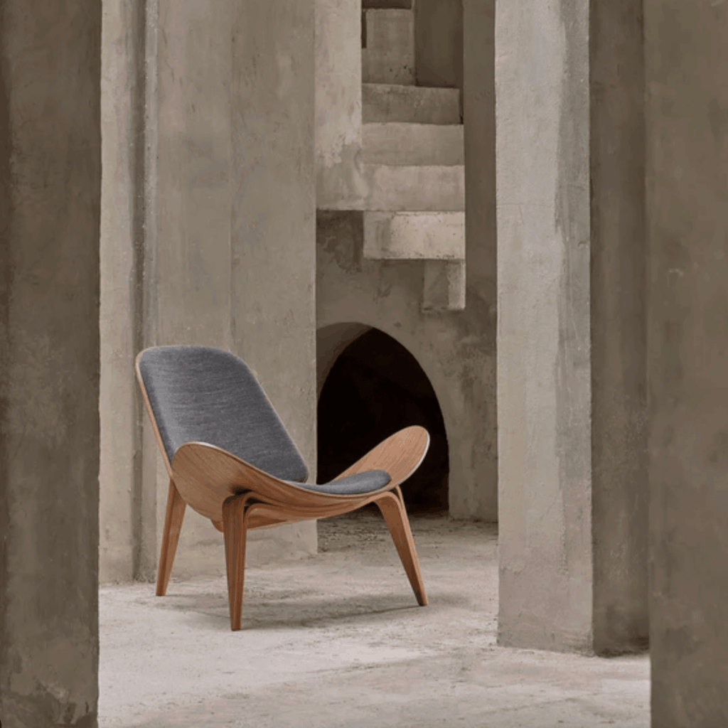 Modern chair with gray cushion in a concrete architectural setting