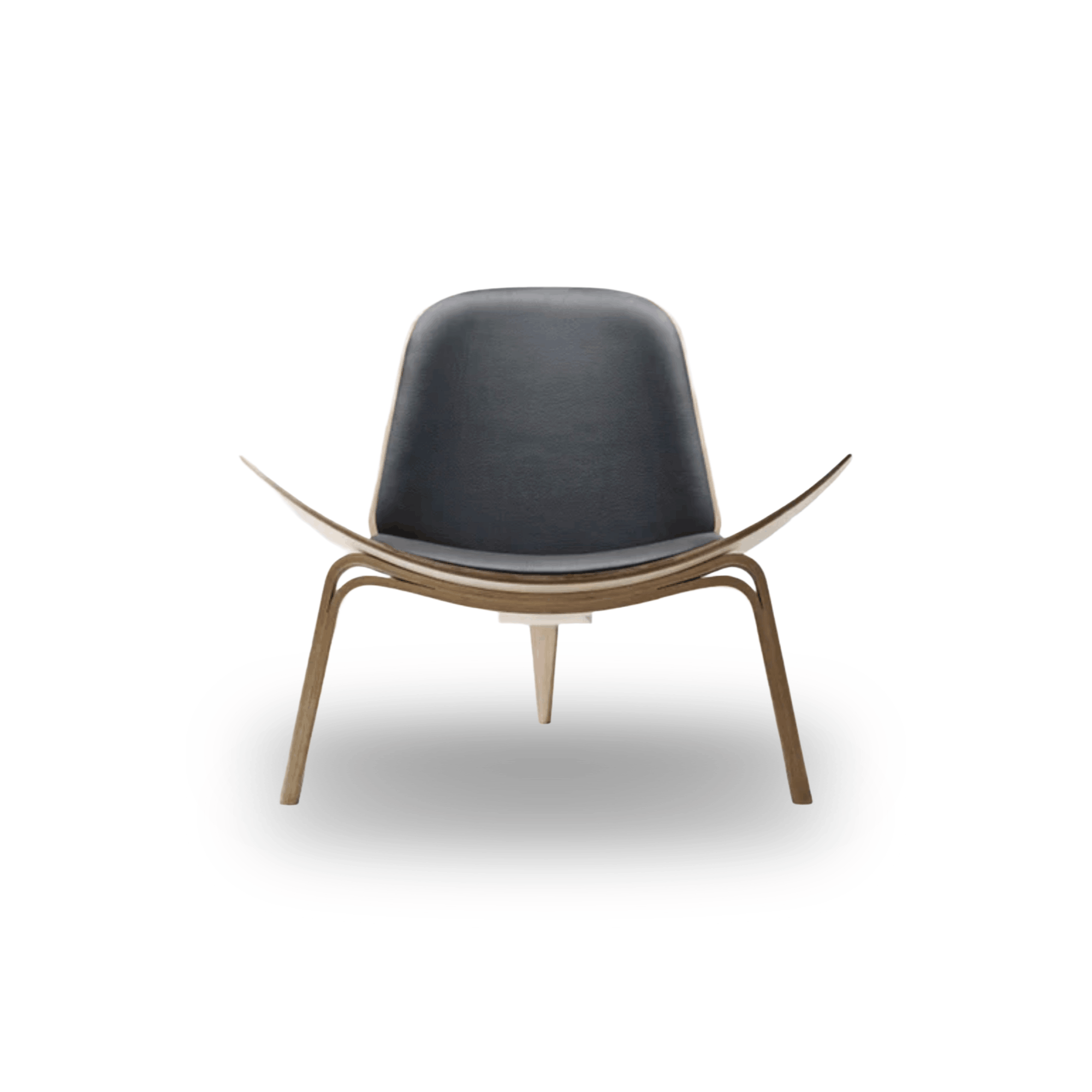 Designed by Hans J. Wegner, the CH07 Shell Chair features a form-pressed veneer shell, leather upholstery, and iconic Scandinavian styling.