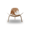 Designed by Hans J. Wegner, the CH07 Shell Chair features a form-pressed veneer shell, leather upholstery, and iconic Scandinavian styling.