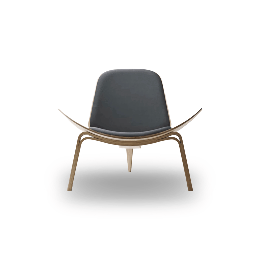 Designed by Hans J. Wegner, the CH07 Shell Chair features a form-pressed veneer shell, leather upholstery, and iconic Scandinavian styling.