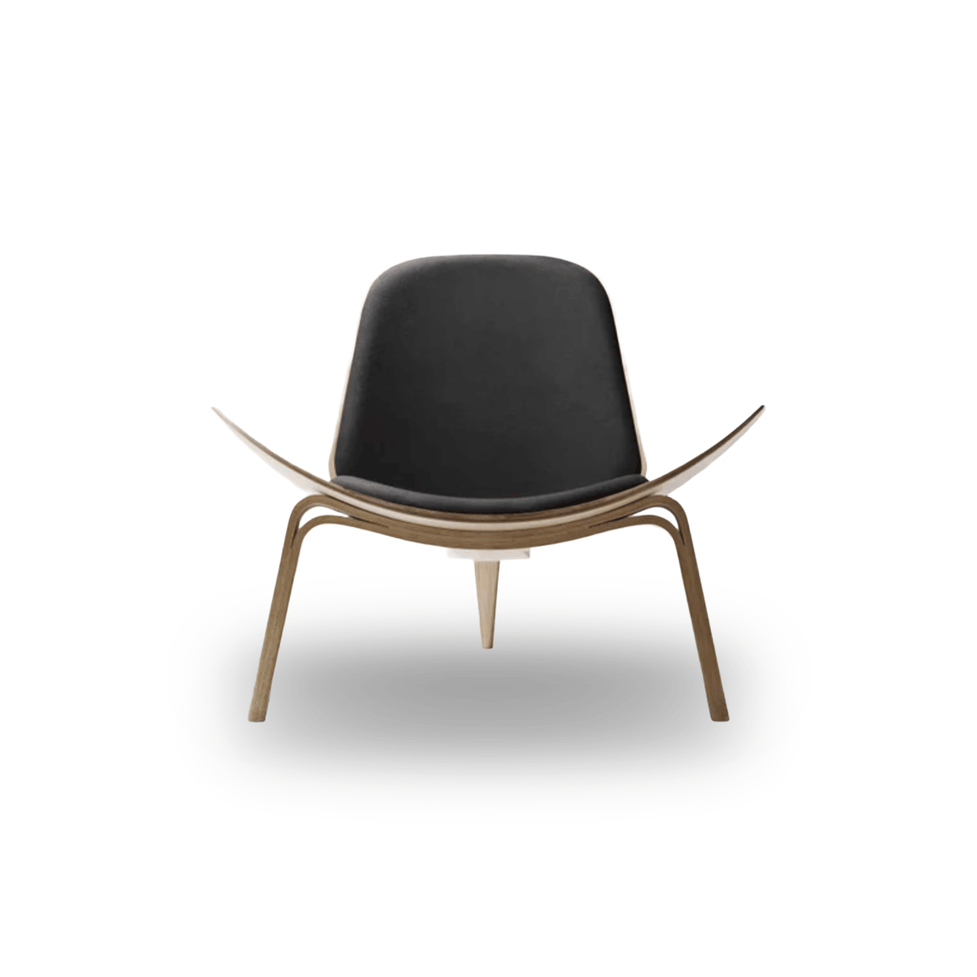 Designed by Hans J. Wegner, the CH07 Shell Chair features a form-pressed veneer shell, leather upholstery, and iconic Scandinavian styling.
