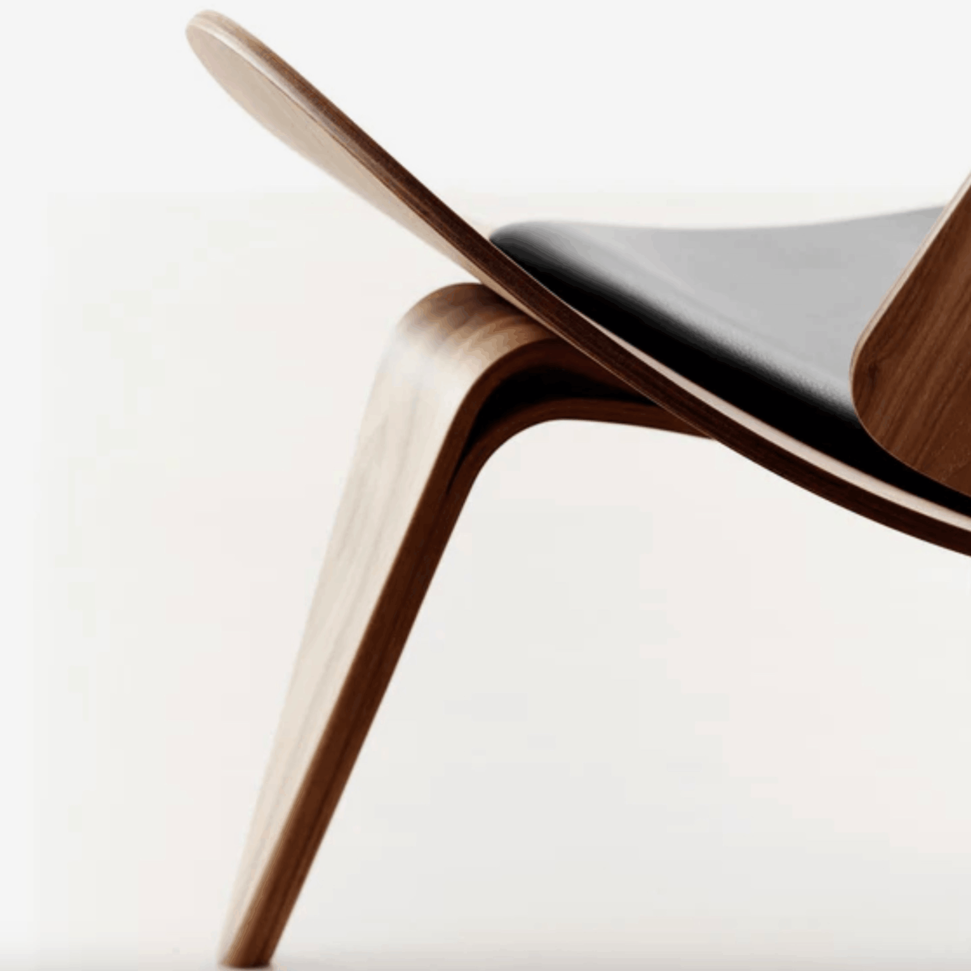 Close-up of a modern chair with wooden legs and backrest on a white background