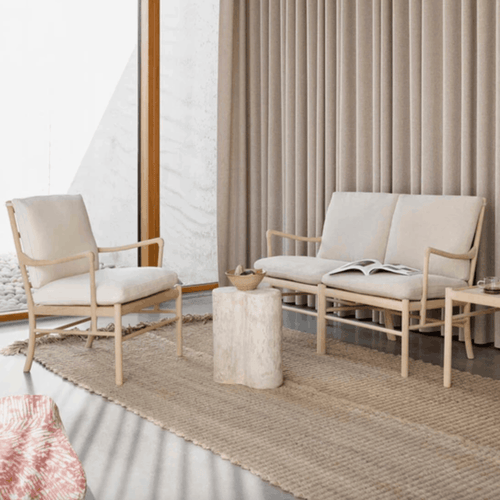 A beautifully crafted oak sofa with soft Re-wool upholstery, bringing understated luxury and enduring comfort to contemporary interiors.