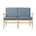 Two-seater sofa with blue cushions and wooden frame on a white background