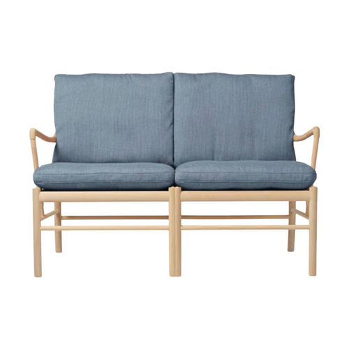 Two-seater sofa with blue cushions and wooden frame on a white background