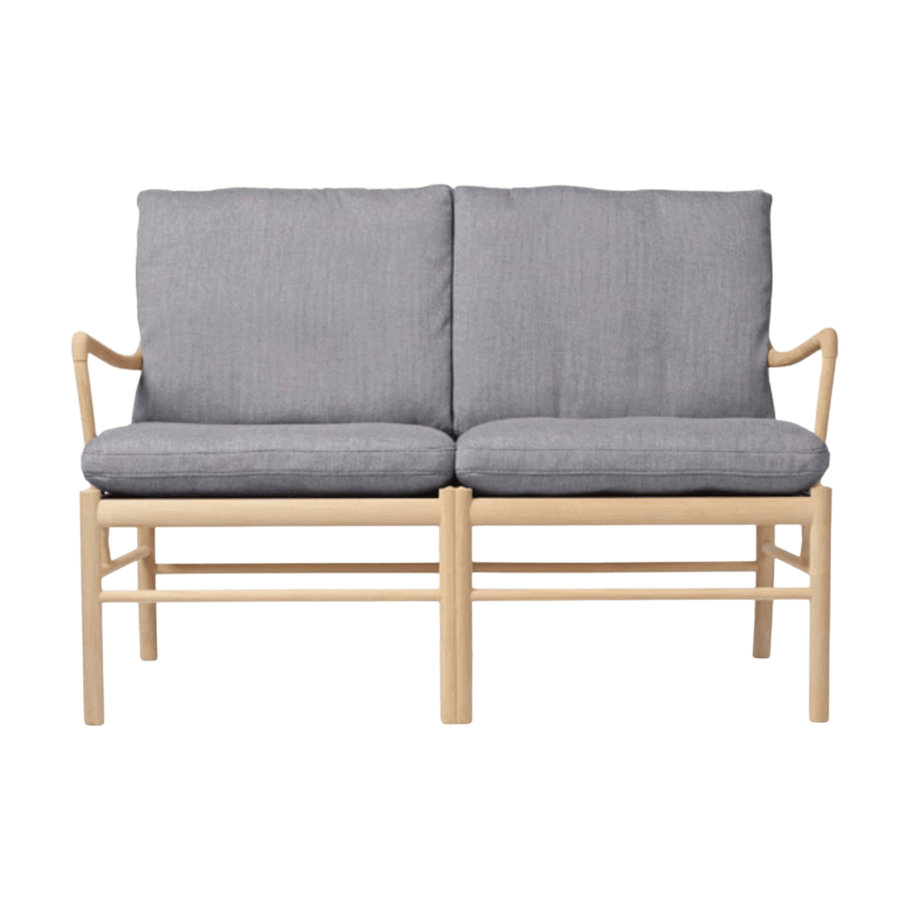Two-seater sofa with gray cushions and wooden frame on a white background