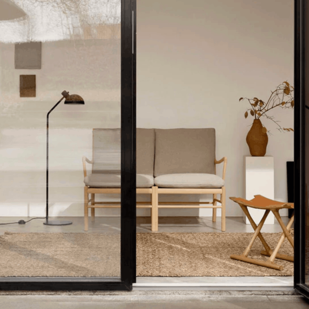 Modern interior with a sofa, chair, and decorative elements in a neutral color scheme.