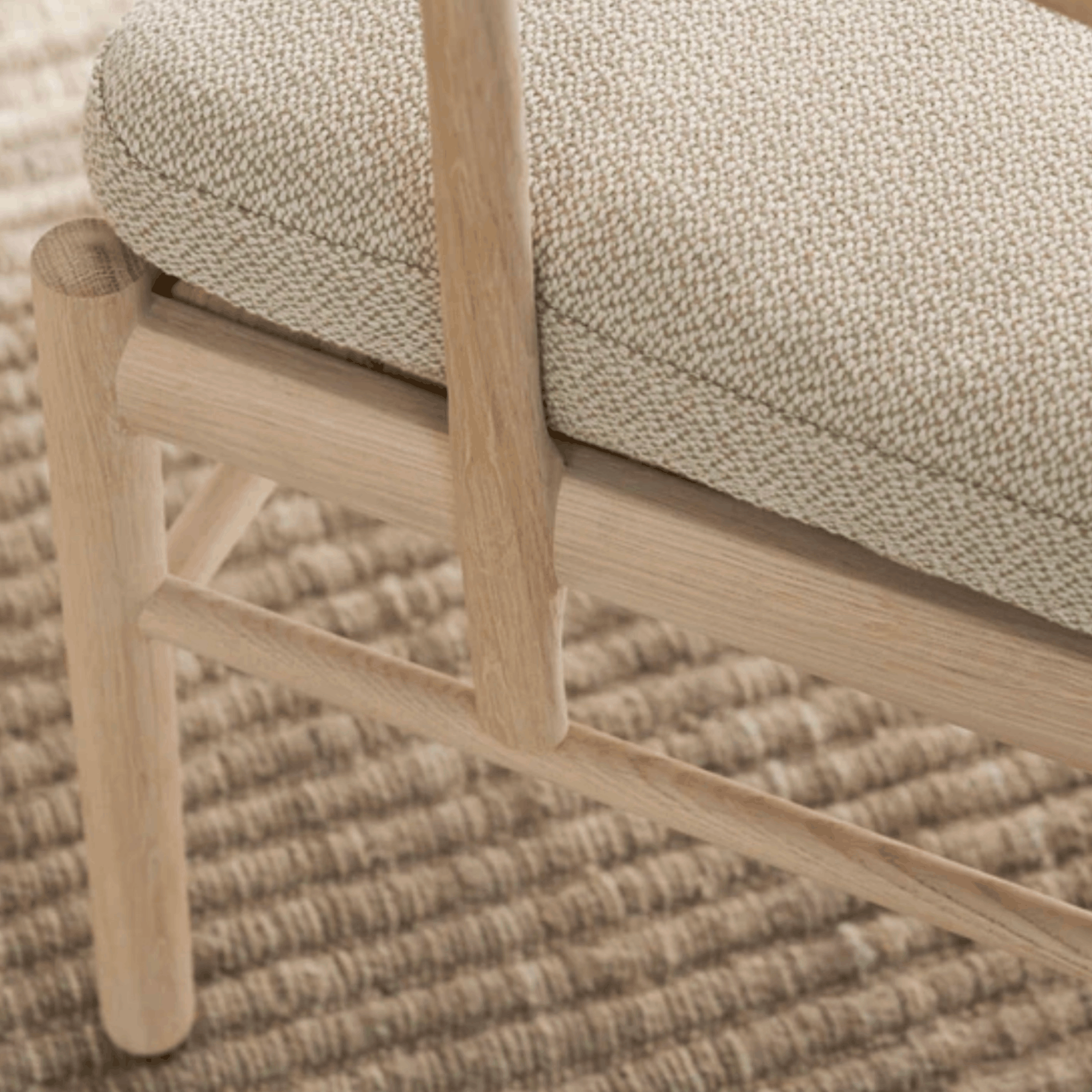 Close up of chair with woven seat and backrest on a textured surface. 