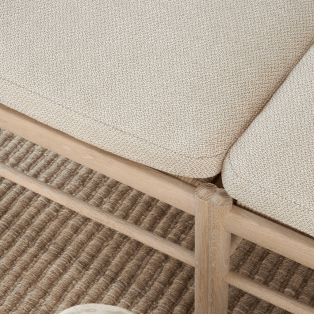 Close-up of a textured beige fabric surface with wooden frame