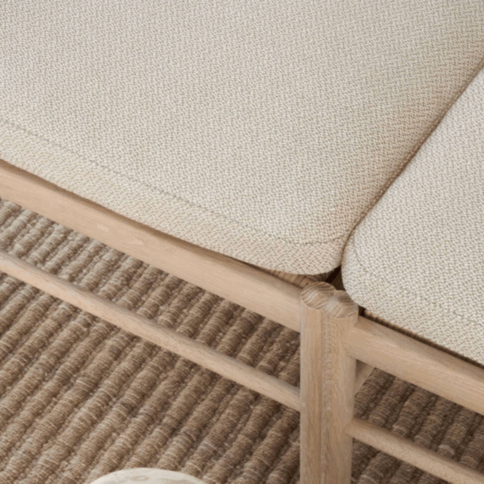 Close-up of a textured beige fabric surface with wooden frame
