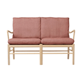 Two-seater sofa with pink cushions and wooden frame on a white background
