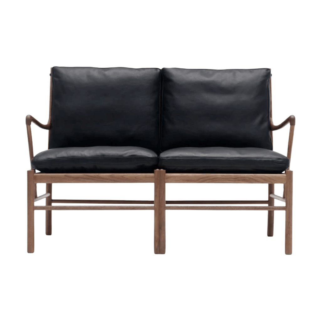 Black leather sofa with wooden frame on a white background