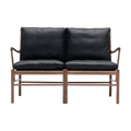 Black leather sofa with wooden frame on a white background