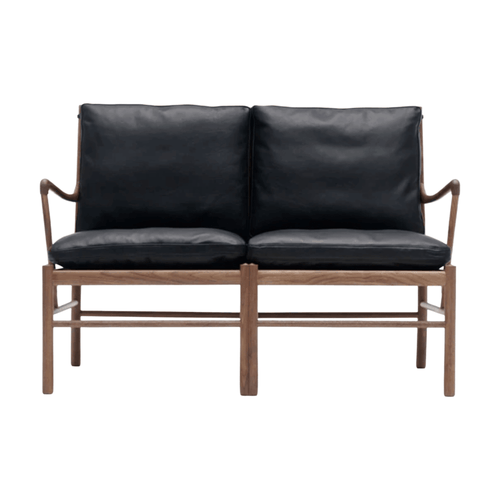 Black leather sofa with wooden frame on a white background