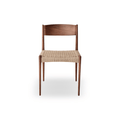 Designed by Poul Cadovius, the DK3 Pia Chair features solid walnut construction, a hand-woven paper cord seat, and refined Scandinavian styling.