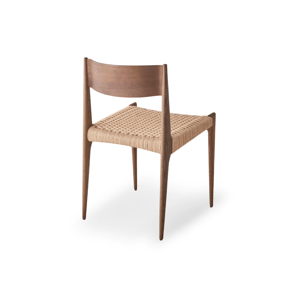 Designed by Poul Cadovius, the DK3 Pia Chair features solid walnut construction, a hand-woven paper cord seat, and refined Scandinavian styling. Rear View.