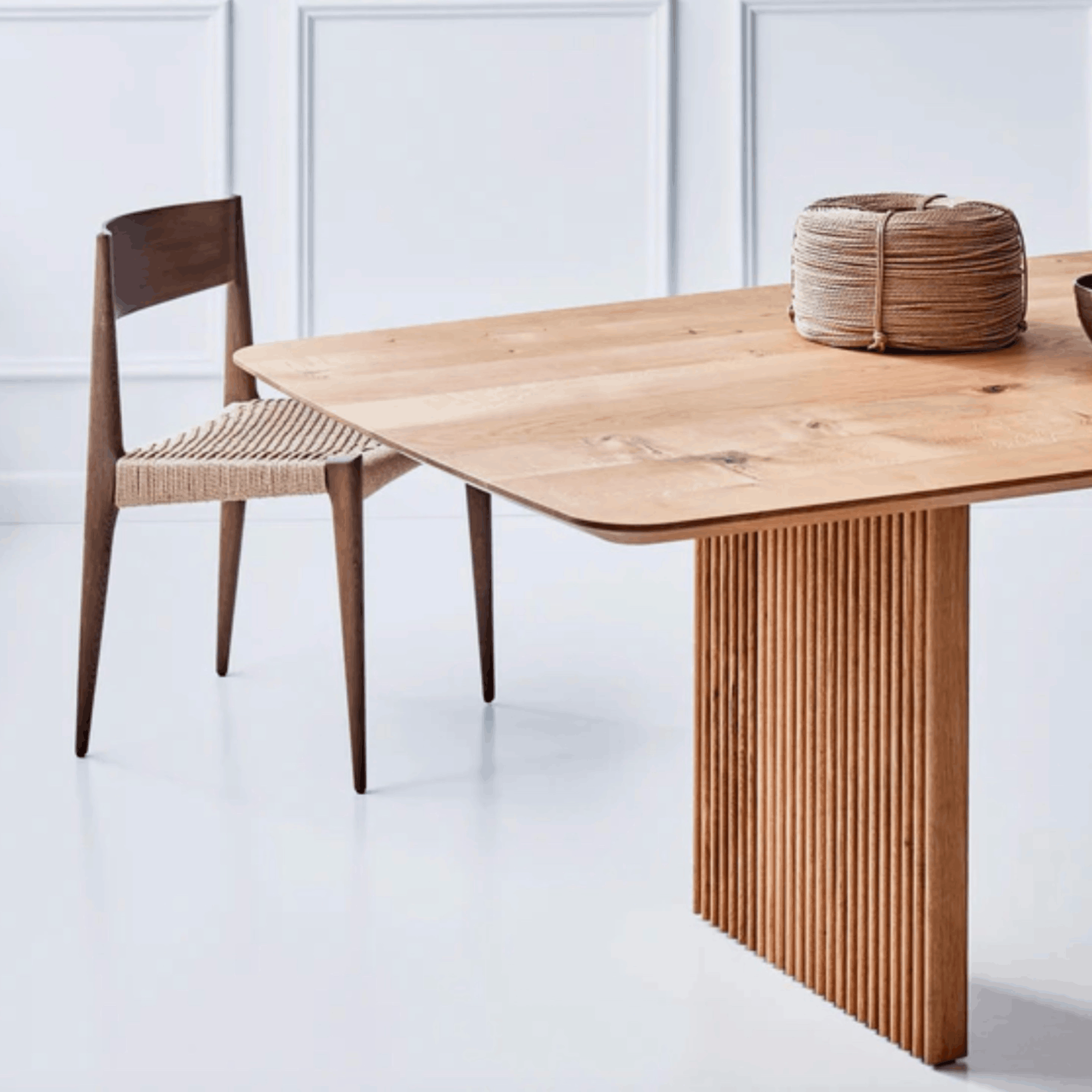 Wooden dining table with a chair in a minimalistic setting