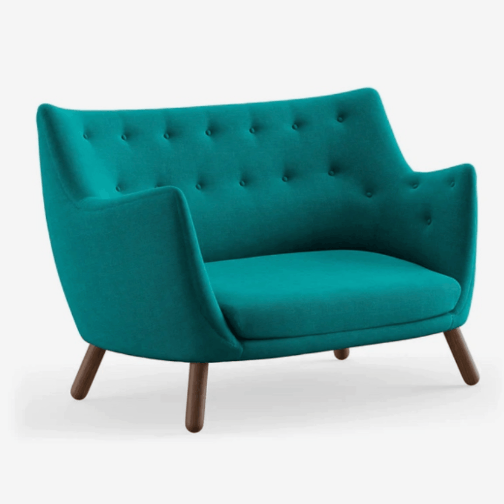 The Finn Juhl Poet Sofa in Walnut combines sculptural Danish design, luxurious upholstery and exceptional craftsmanship in an iconic two-seater sofa.