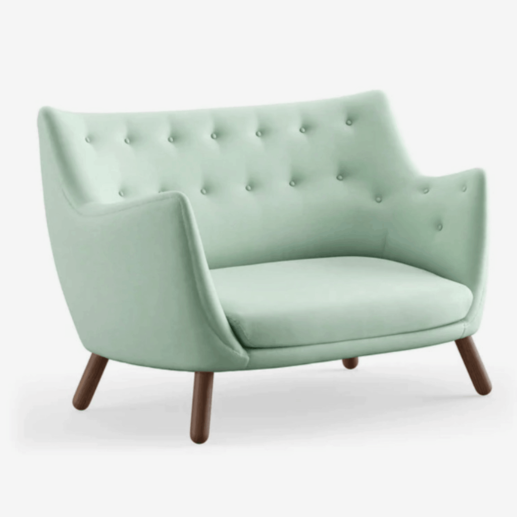 The Finn Juhl Poet Sofa in Walnut combines sculptural Danish design, luxurious upholstery and exceptional craftsmanship in an iconic two-seater sofa.