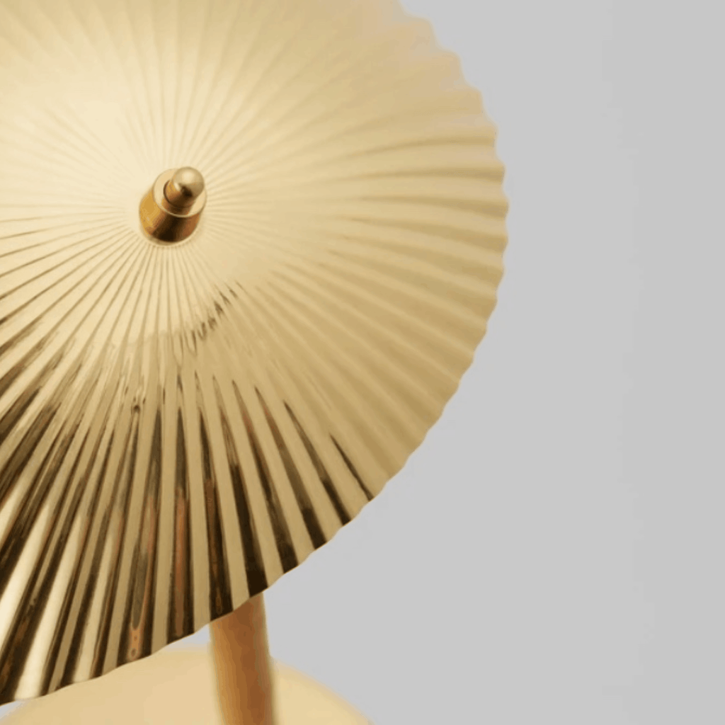 Close up of the shell pattern on the shade of the GUBI 5321 Table Lamp by Paavo Tynell with sculptural brass seashell shade and elegant Scandinavian design.