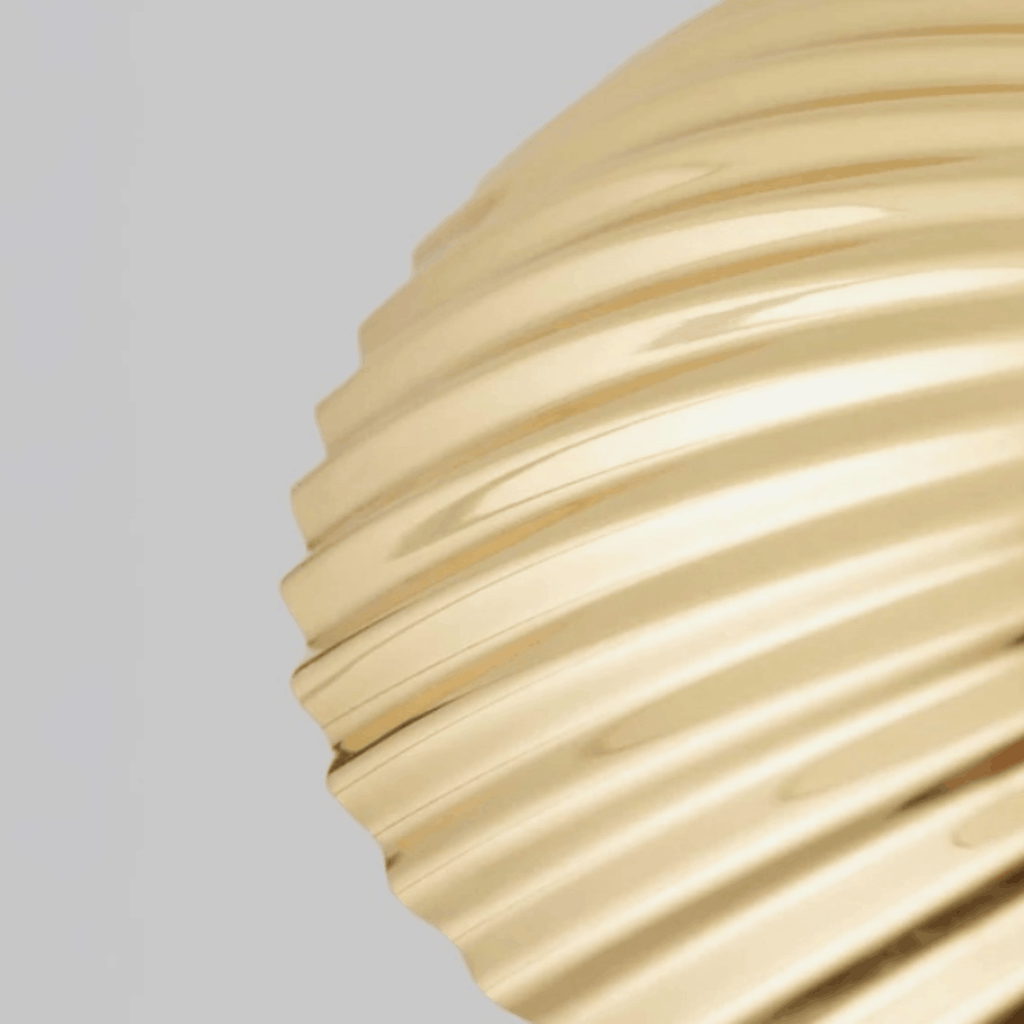 Close up of the shell pattern on the shade of the GUBI 5321 Table Lamp by Paavo Tynell with sculptural brass seashell shade and elegant Scandinavian design.