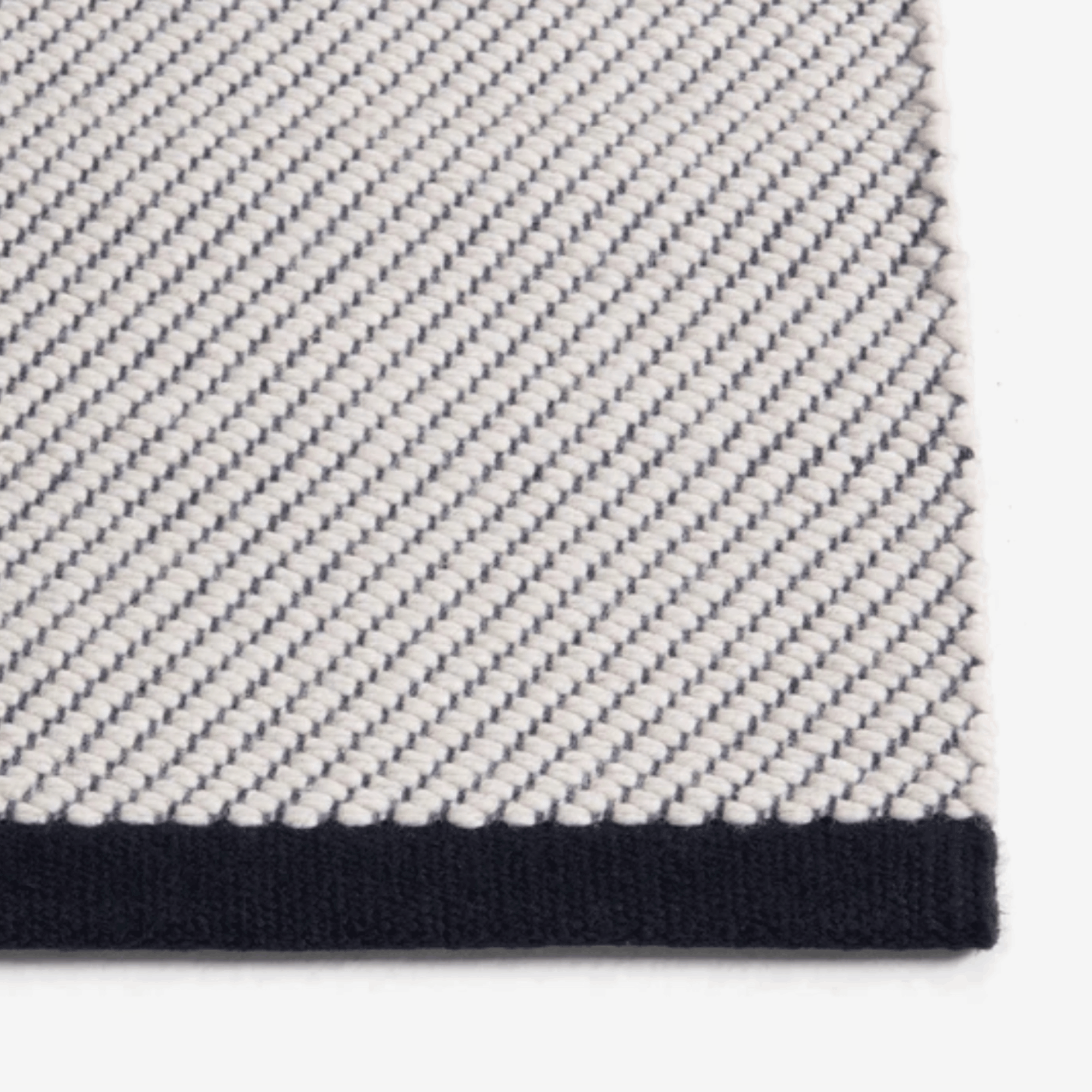 Contemporary wool rug by HAY with a refined diagonal weave, two-tone effect, and OEKO-TEX® STANDARD 100 certification.