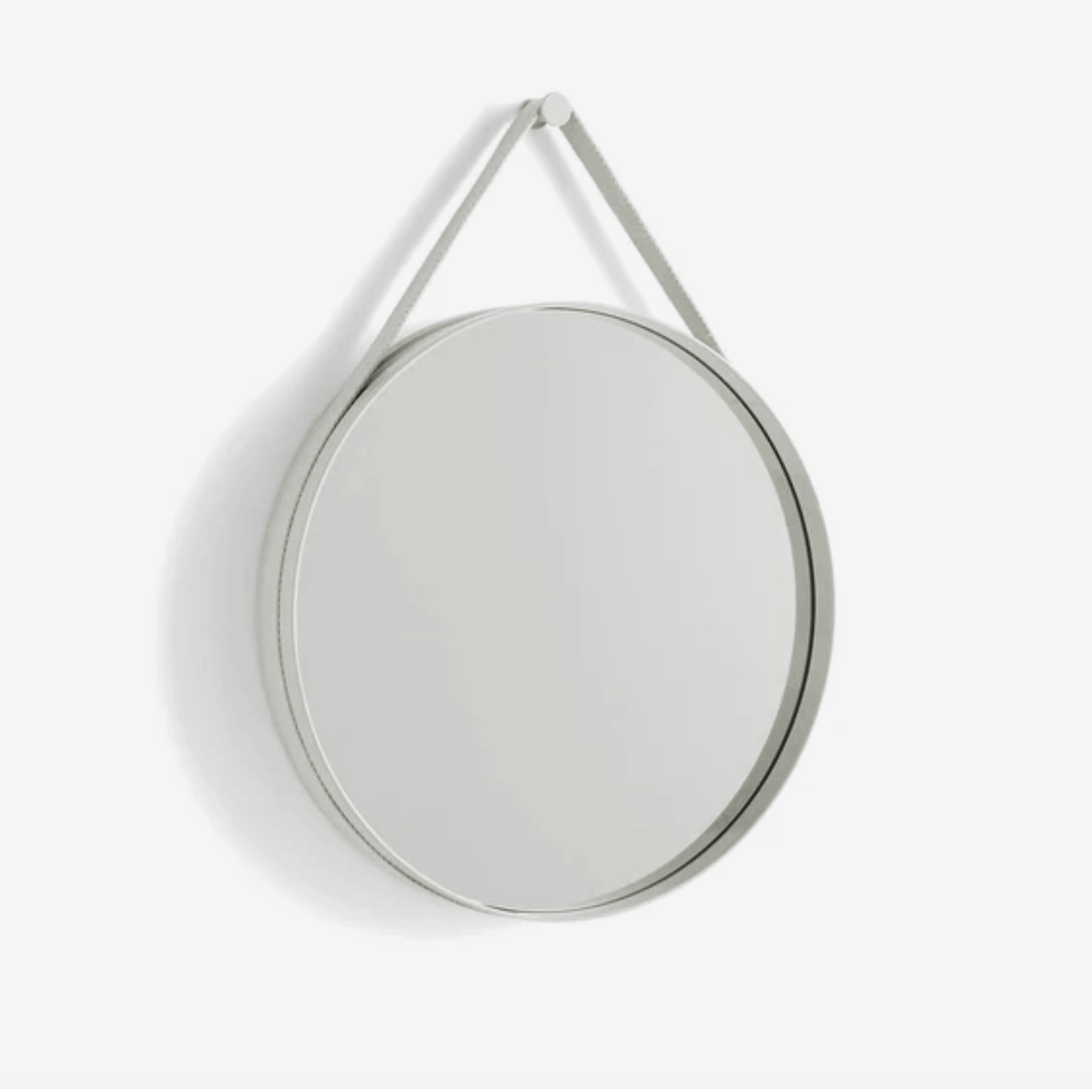 A contemporary round wall mirror by HAY featuring a minimalist steel strap design, perfect for bedrooms, bathrooms, and hallways.