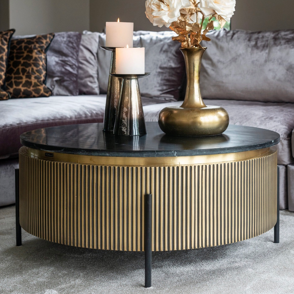 Ironville 90cm round coffee table featuring black marble, brass accents and iron base – a statement piece for modern interiors.