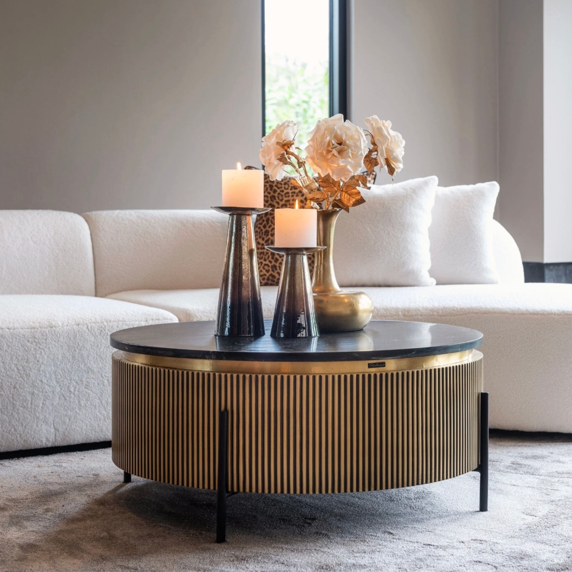 Ironville 90cm round coffee table featuring black marble, brass accents and iron base – a statement piece for modern interiors.