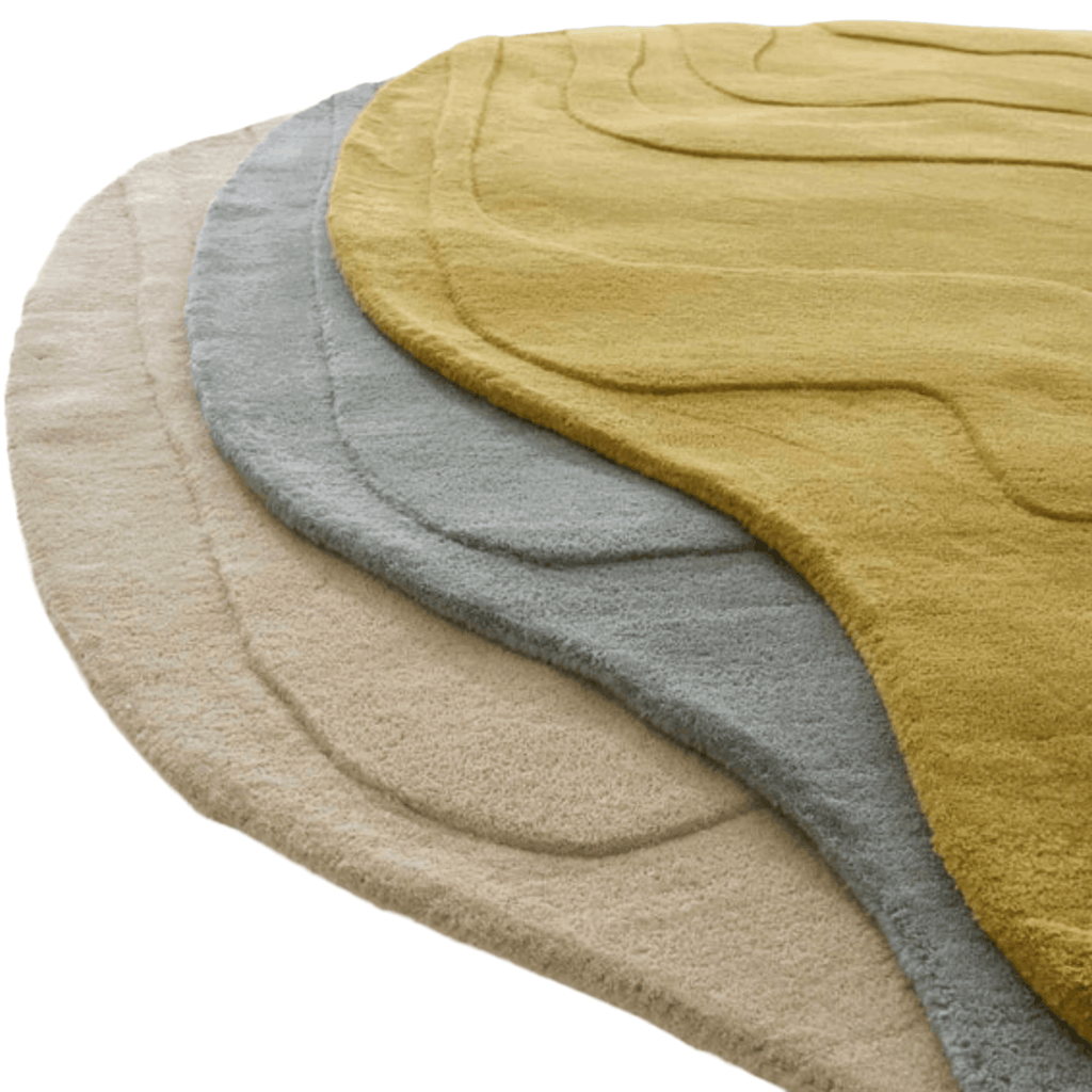 Three circular rugs in mustard, grey blue, and beige on a white background