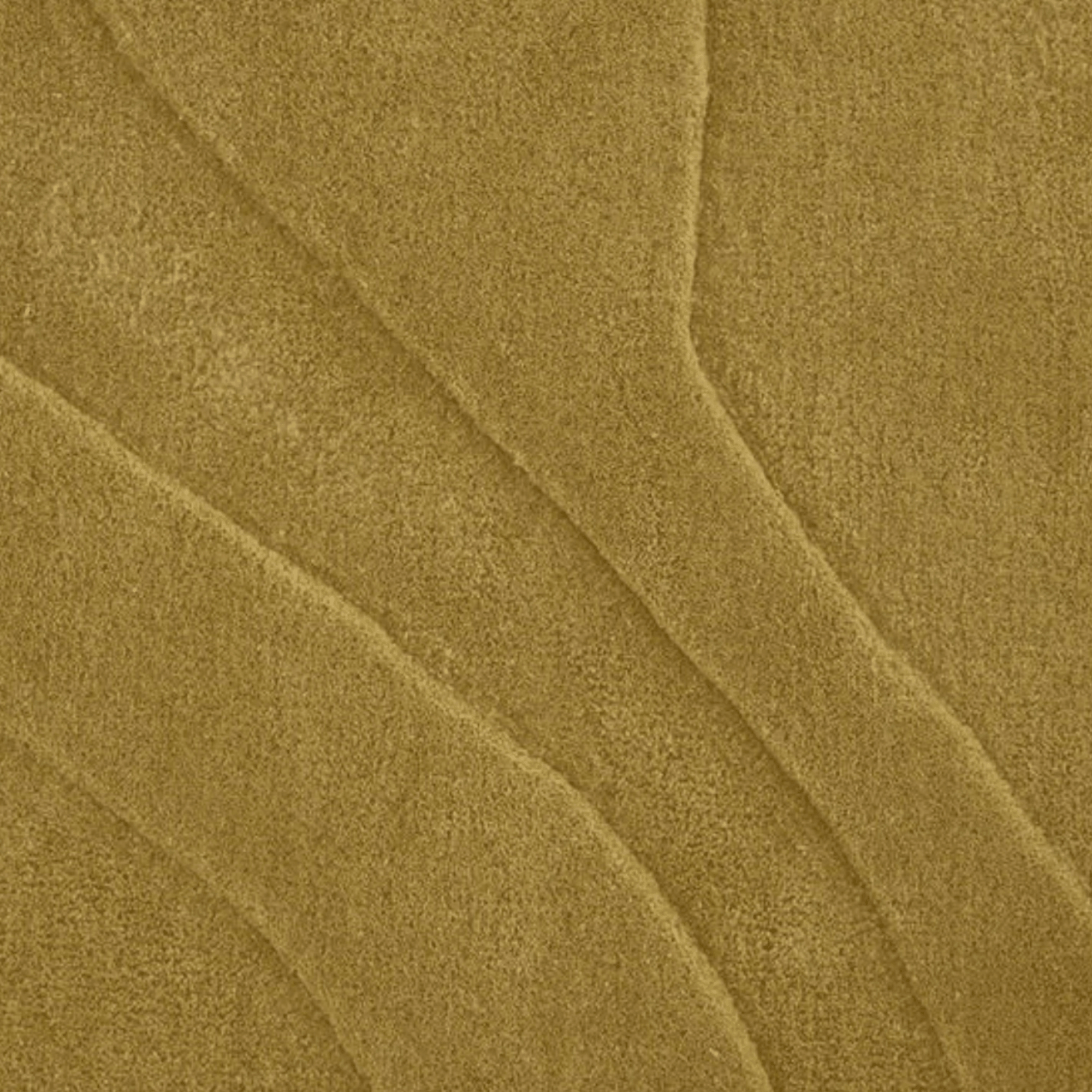 Close-up of a textured mustard fabric surface of a Lignet Roset Gavrinis rug