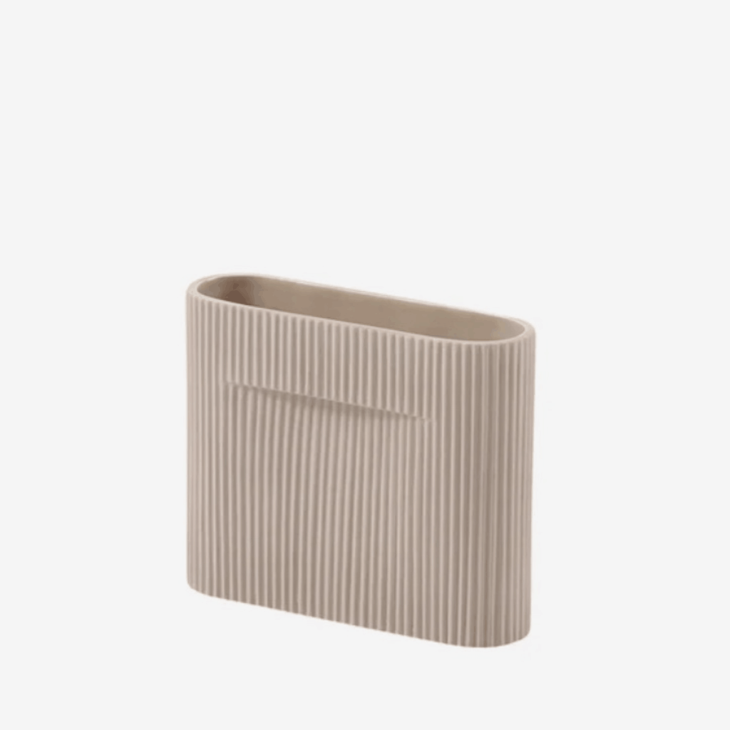 The Muuto Ridge Vase is a contemporary earthenware vase featuring a distinctive sculptural silhouette and innovative central indentation that supports floral arrangements while doubling as a practical handle. Its compact size makes it ideal for shelves, side tables, consoles and modern Scandinavian interiors.