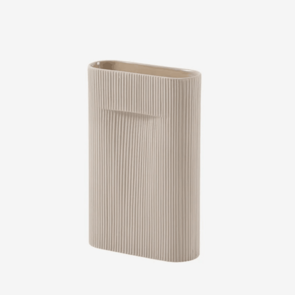 The Muuto Ridge Vase is a contemporary earthenware vase featuring a distinctive sculptural silhouette and innovative central indentation that supports floral arrangements while doubling as a practical handle. Perfect as a statement decorative object or elegant vase for modern Scandinavian interiors.