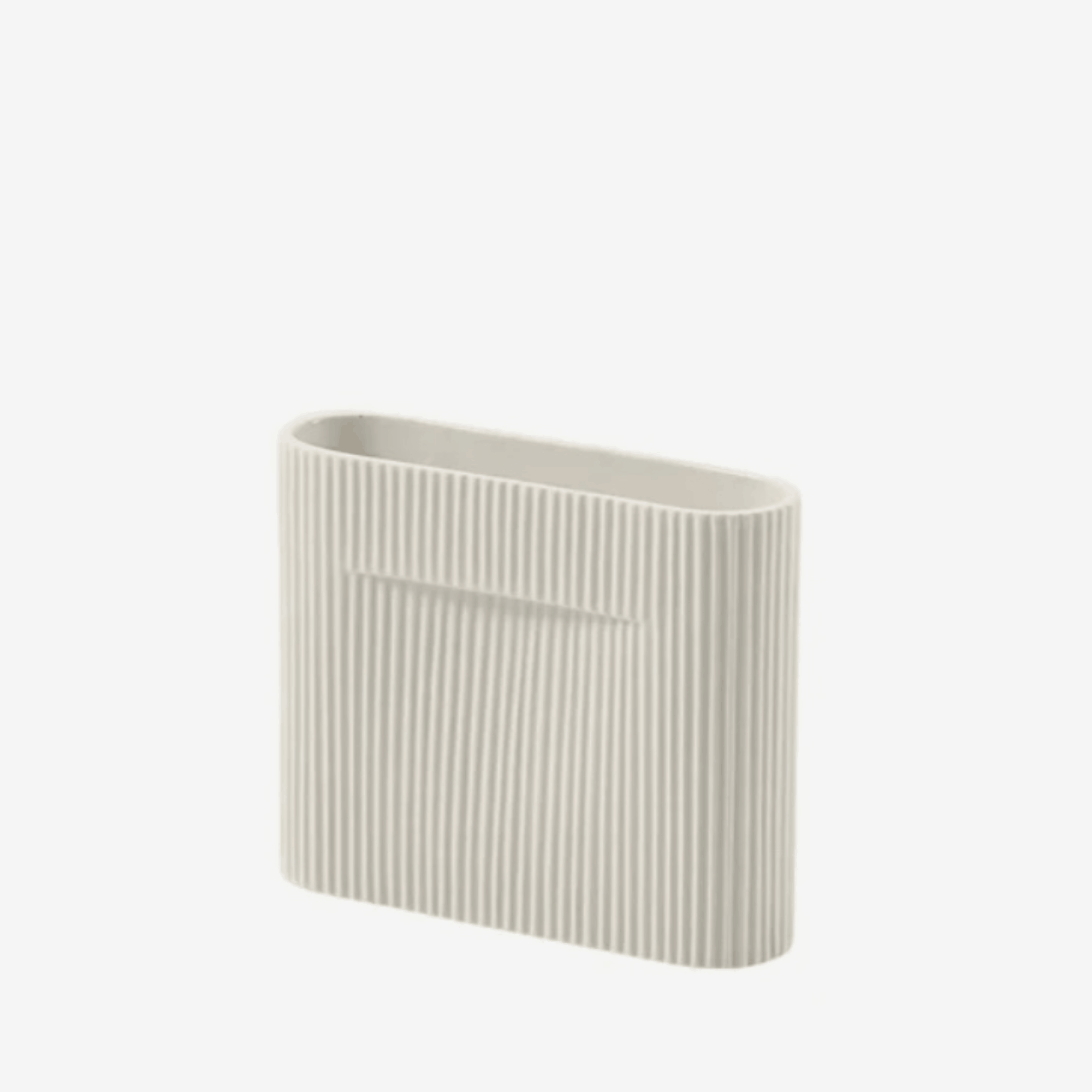 The Muuto Ridge Vase is a contemporary earthenware vase featuring a distinctive sculptural silhouette and innovative central indentation that supports floral arrangements while doubling as a practical handle. Its compact size makes it ideal for shelves, side tables, consoles and modern Scandinavian interiors.