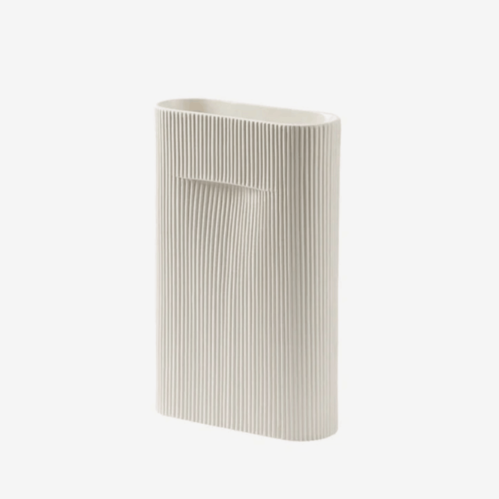 The Muuto Ridge Vase is a contemporary earthenware vase featuring a distinctive sculptural silhouette and innovative central indentation that supports floral arrangements while doubling as a practical handle. Perfect as a statement decorative object or elegant vase for modern Scandinavian interiors.