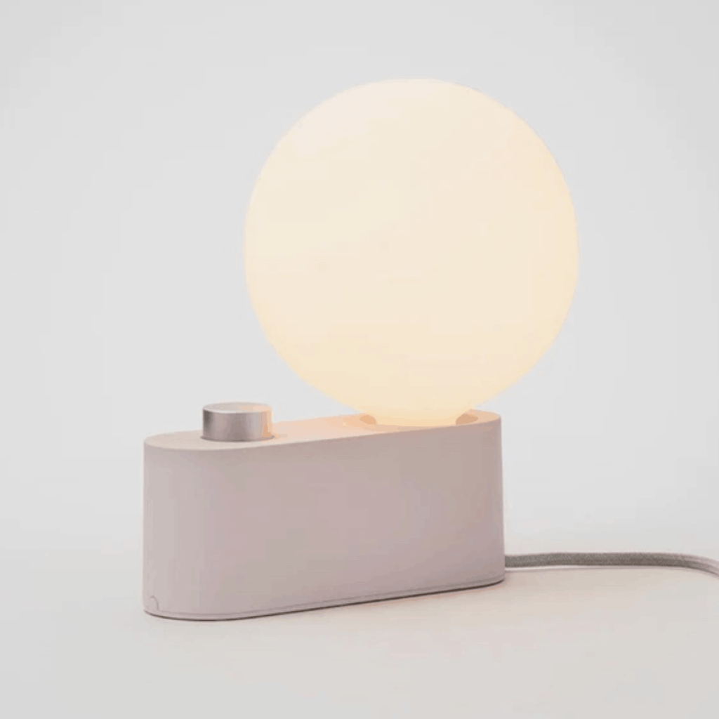 The Tala Alumina Table Lamp is a versatile 2-in-1 designer light that functions as both a table lamp and wall-mounted light. Featuring a minimalist metal construction, fabric cable and mains dimming compatibility, it brings flexible contemporary lighting to modern interiors.