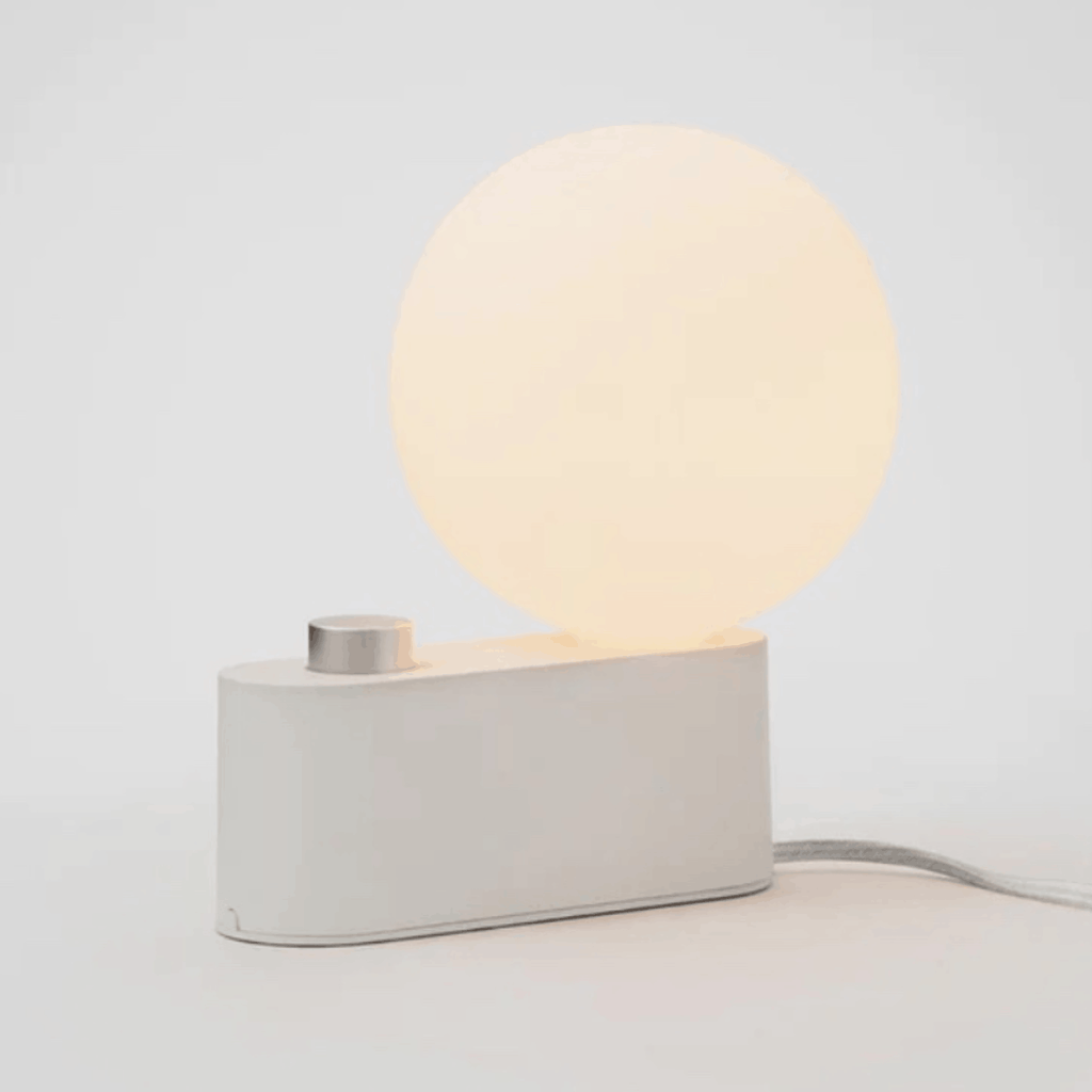 The Tala Alumina Table Lamp is a versatile 2-in-1 designer light that functions as both a table lamp and wall-mounted light. Featuring a minimalist metal construction, fabric cable and mains dimming compatibility, it brings flexible contemporary lighting to modern interiors.