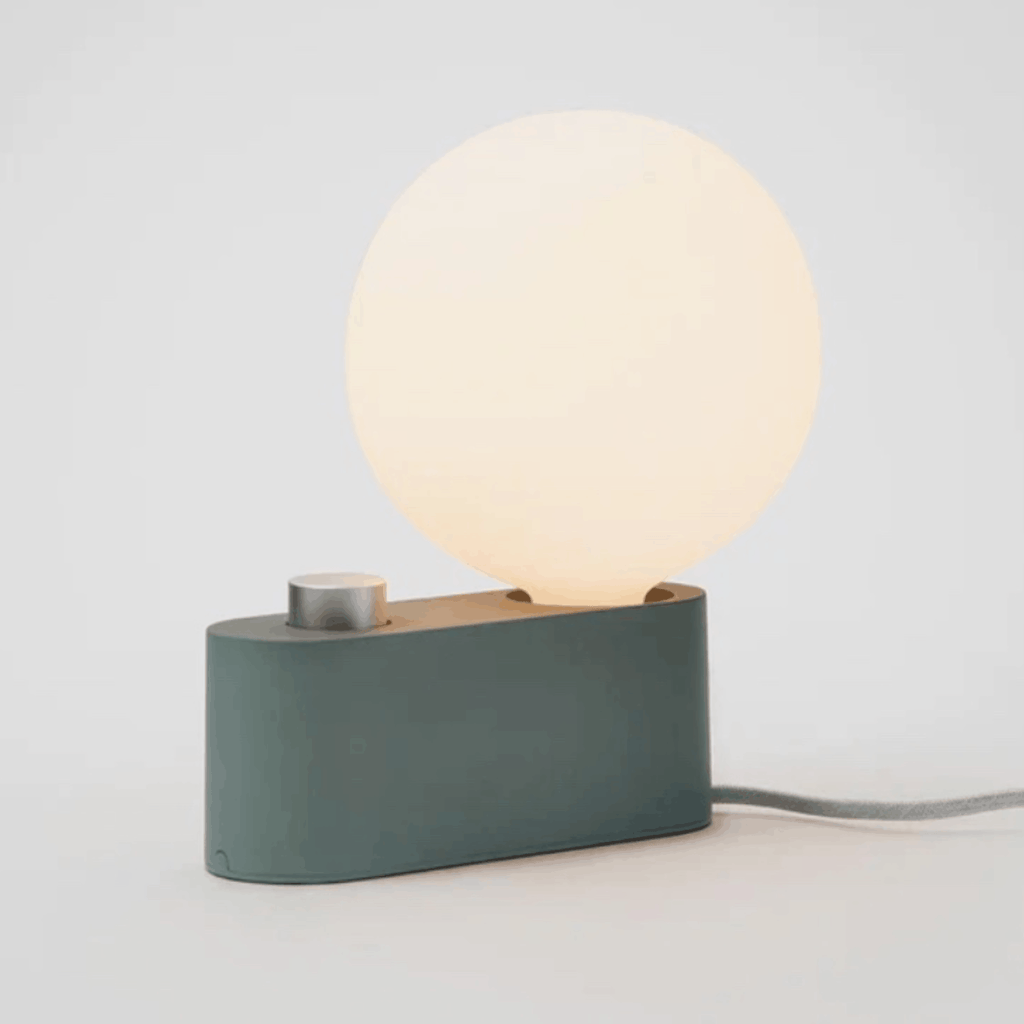 The Tala Alumina Table Lamp is a versatile 2-in-1 designer light that functions as both a table lamp and wall-mounted light. Featuring a minimalist metal construction, fabric cable and mains dimming compatibility, it brings flexible contemporary lighting to modern interiors.