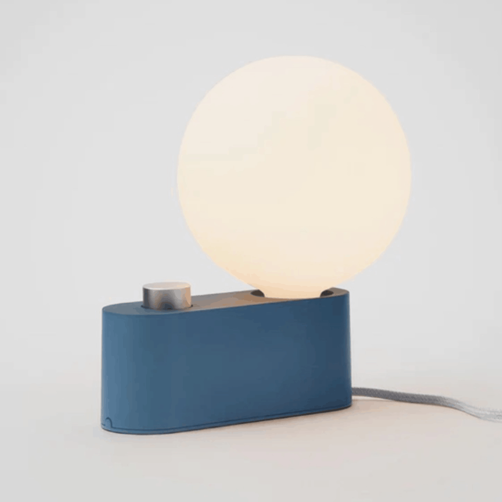 The Tala Alumina Table Lamp is a versatile 2-in-1 designer light that functions as both a table lamp and wall-mounted light. Featuring a minimalist metal construction, fabric cable and mains dimming compatibility, it brings flexible contemporary lighting to modern interiors.