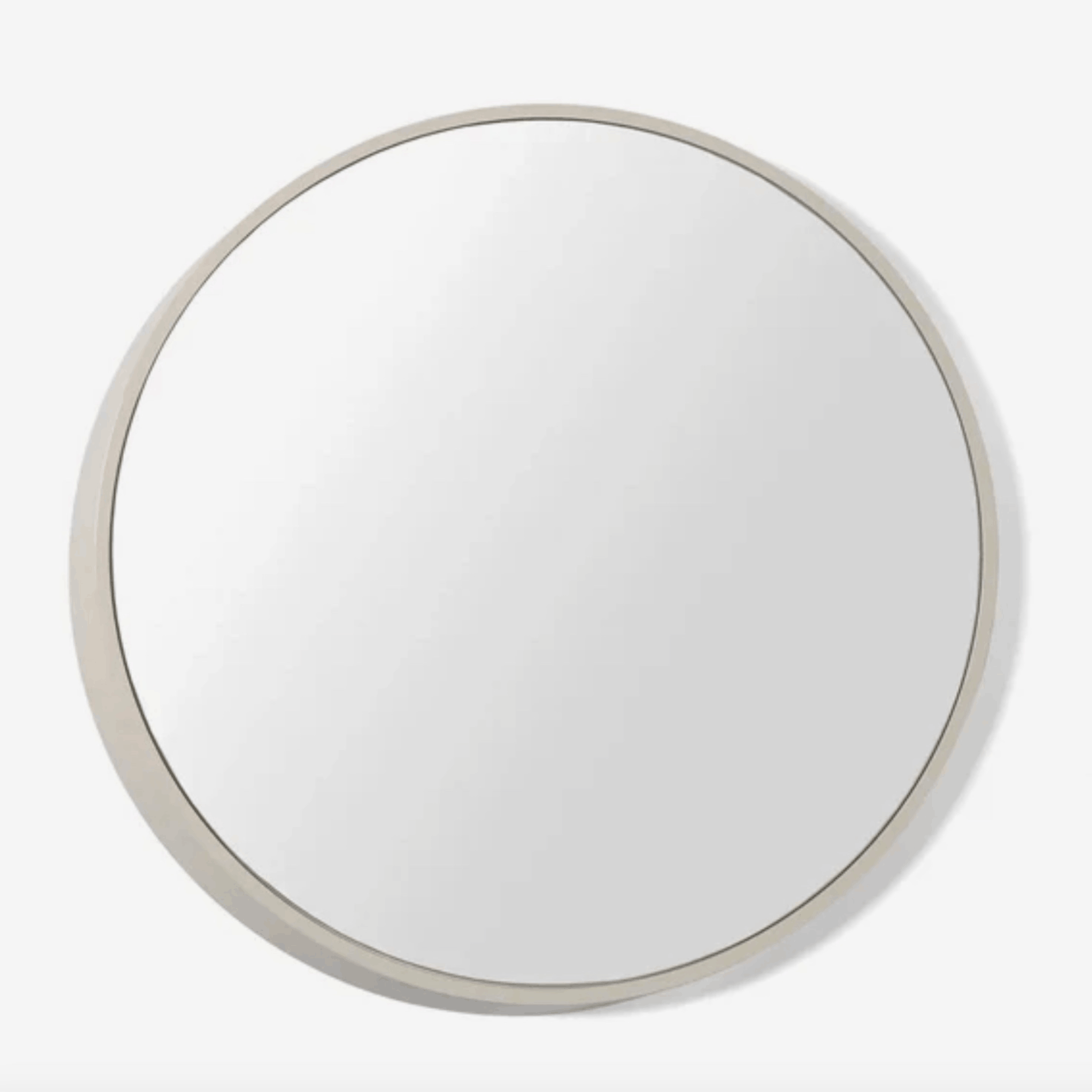A modern round wall mirror with an architectural three-dimensional profile, designed by Sarah Rousselle for The Conran Shop.
