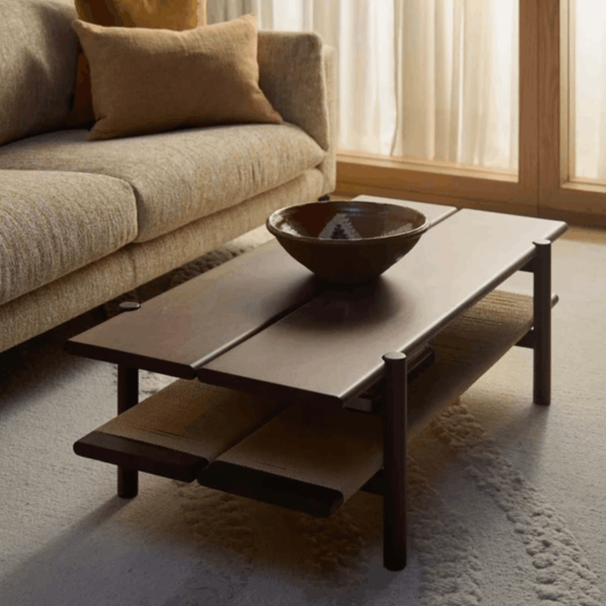 The Conran Shop Pagoda Coffee Table in walnut with a solid wood frame, spacious tabletop and woven papercord storage shelf beneath.